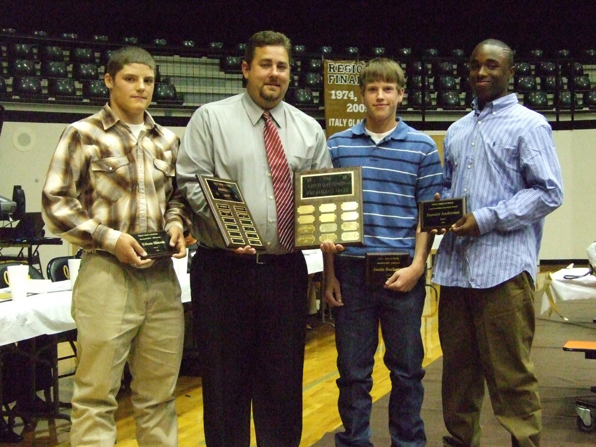 Image: Varsity Baseball winners — (L-R) Ethan Simon, Coach Matt Coker, Justin Buchanan and Jasenio Anderson