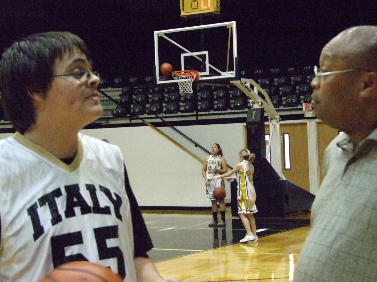 Image: Thinking Things Over — Italy’s #55 Robert “Big Deal” Dellinger converses with Coach Mayberry during halftime.