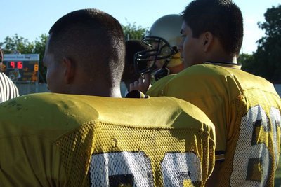 Image: Watching the battle — Jacob Lopez, Omar Estrada and Jase Holden looking on from the sidelines.