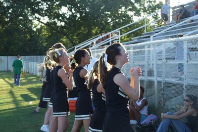 Image: We’ve got spirit — The  JV cheerleaders clap and shout, looking to raise the spirit of the people in the stands.