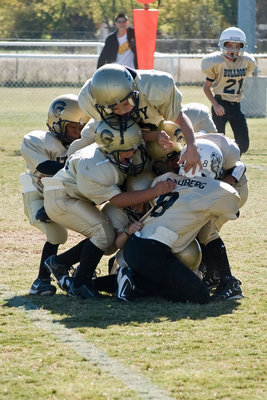 Image: “Dog Pile!” — The Gladiator defense is having a team meeting.