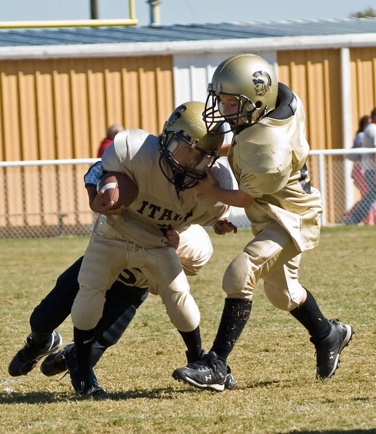 Image: This Way! — Tylan Wallace tries to break away with help from Isaac Salcido.