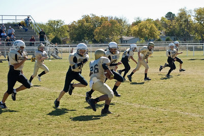 Image: Busting Loose — A-Team quarterback Kenneth Norwood scampers.