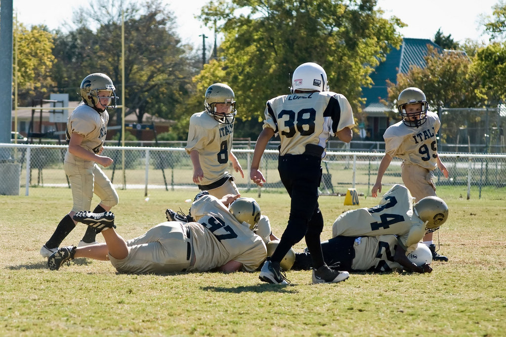 Image: Hard Tackle — 97-Kelton Bales and 34-Lamondre Johnson crunch the Palmer runner.