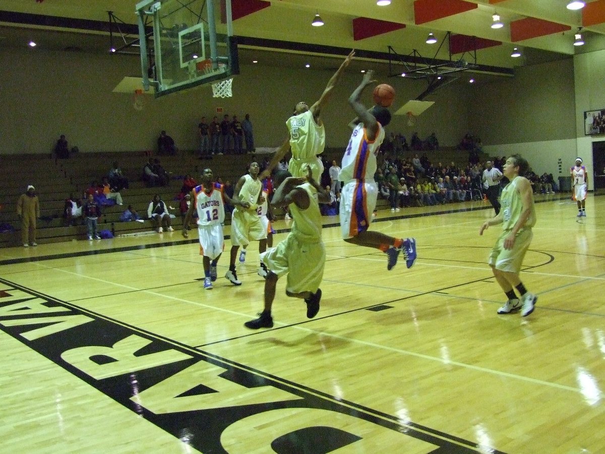 Image: Look Out Below — Italy’s #5 Dontavius Clemons climbs high for a block against the Dallas Gateway’s 6’ 6" big man. It was not easy, but Italy managed to out run, out leap and out last the Gators for a last second victory 87-85. The game was played at Cedar Valley College in Lancaster Friday night.