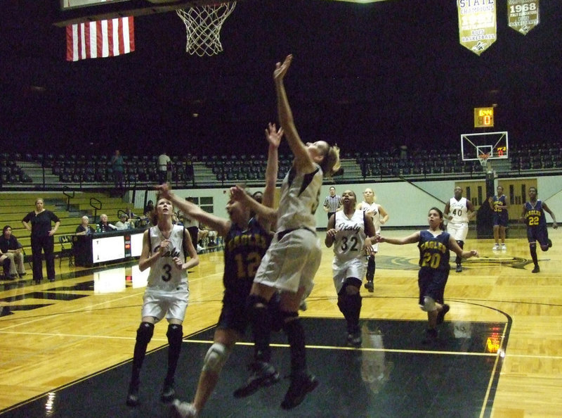 Image: DeMoss shoots and scores — The “Famous Five” resembled a jail break as they released down the court.