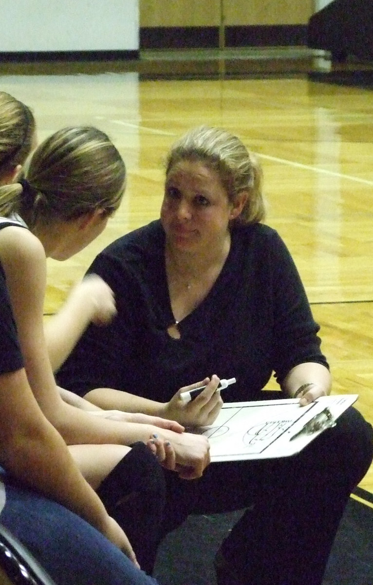 Image: The Mastermind — Coach McDonald gives instruction to Kaitlyn Rossa showing how to make a break for the goal.