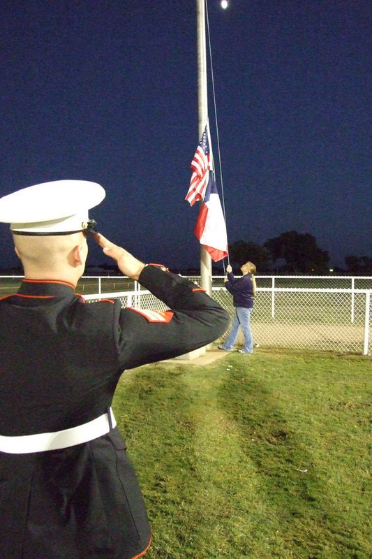 Image: Jacob Simon — Jacob Simon stands at attention as the flag is raised. Simon graduated in 2005 from IHS and has served seven months in Iraq.  He still serves our country today.