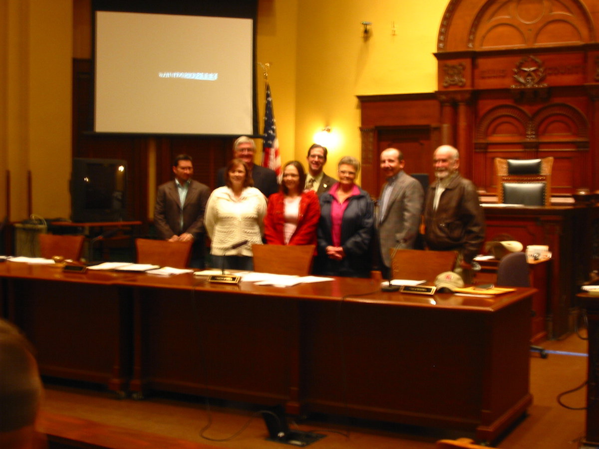 Image: Ellis County District Courtroom — Front Row: Commissioner Dennis Robinson, Sandy Eubank, Amber Hudson, Doris Mitchell, Commissioner Heath Sims, Commissioner Ron Brown  Back Row: Commissioner Bill Dodson, County Judge Chad Adams