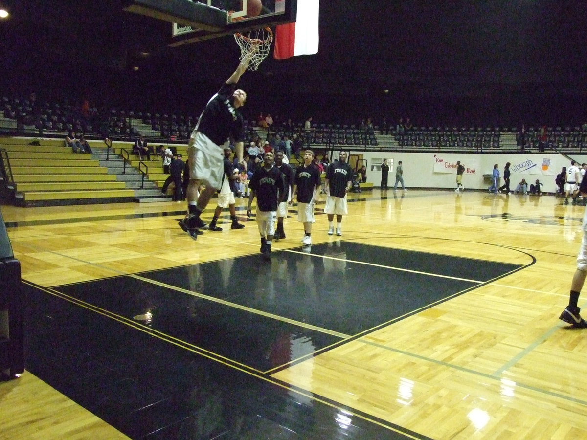 Image: “Wild Thing” Wilkins — Kyle Wilkins seems to be trying to match Harlem Globetrotter, Michael “Wild Thing” Wilson’s, world record in the vertical slam dunk. Wilson set the record on April 1, 2000, by successfully dunking on a 12-foot basket. The event, which took place at Indianapolis’ Conseco Fieldhouse, marked the Harlem Globetrotters’ first-ever appearance at Final Four Weekend.