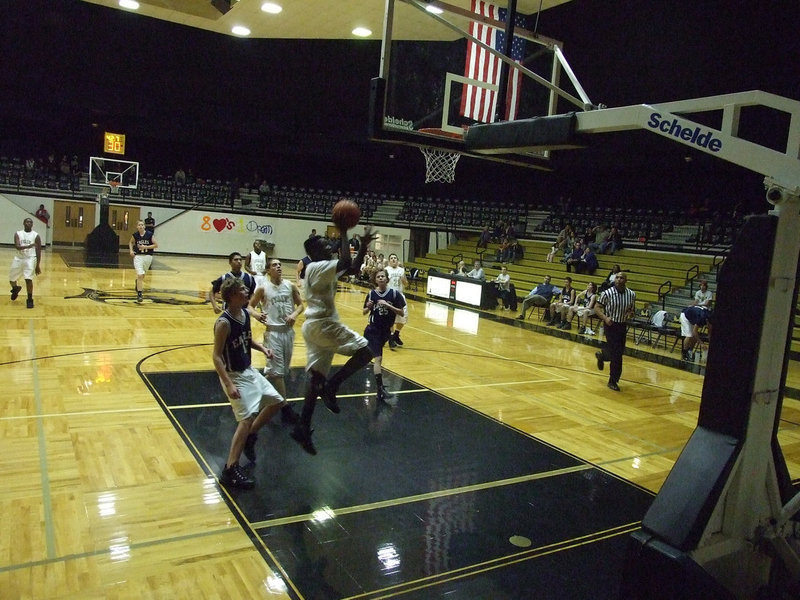 Image: “Flight Time” Frazier — Corrin climbs to the rim for 2-points.