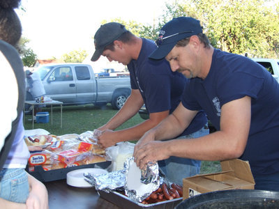 Image: Milford Fire Department — Firemen Joe Chadwick and Scott Kelley are serving the public with hotdogs and hamburgers.