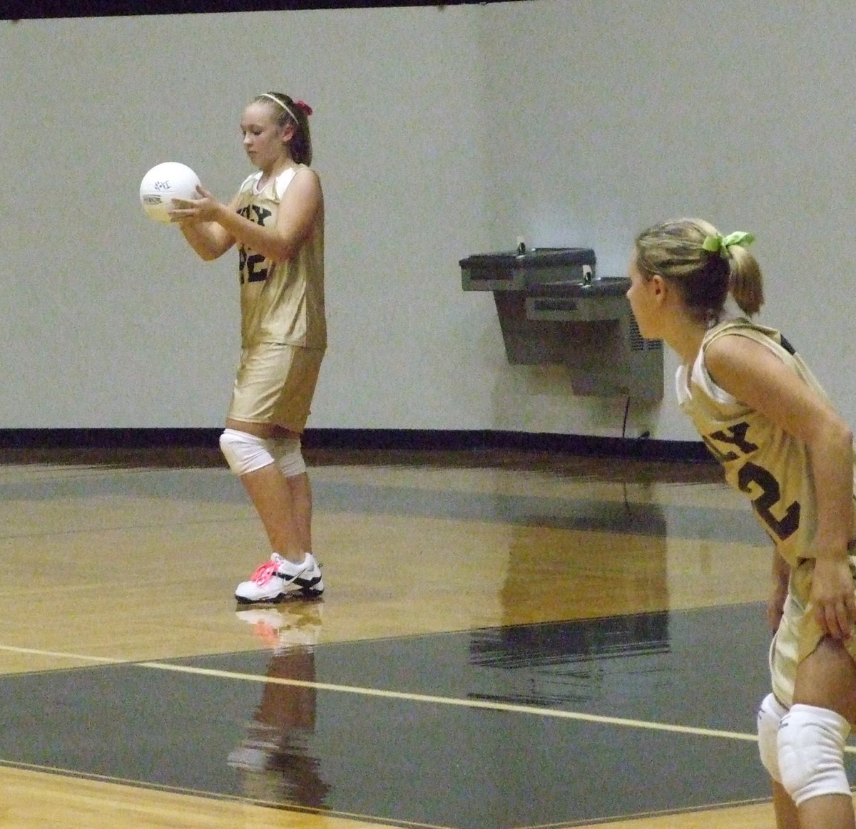 Image: Lewis is ready to serve — Jaclynn Lewis and Bailey Eubank get ready.