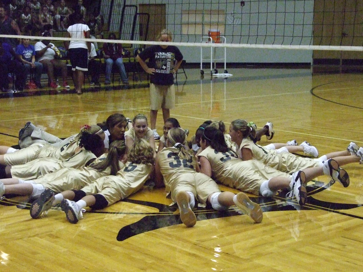 Image: Leadership — Even Coach Richards joins the fun on the floor teaching these rookie Lady Gladiators the after game tradition.