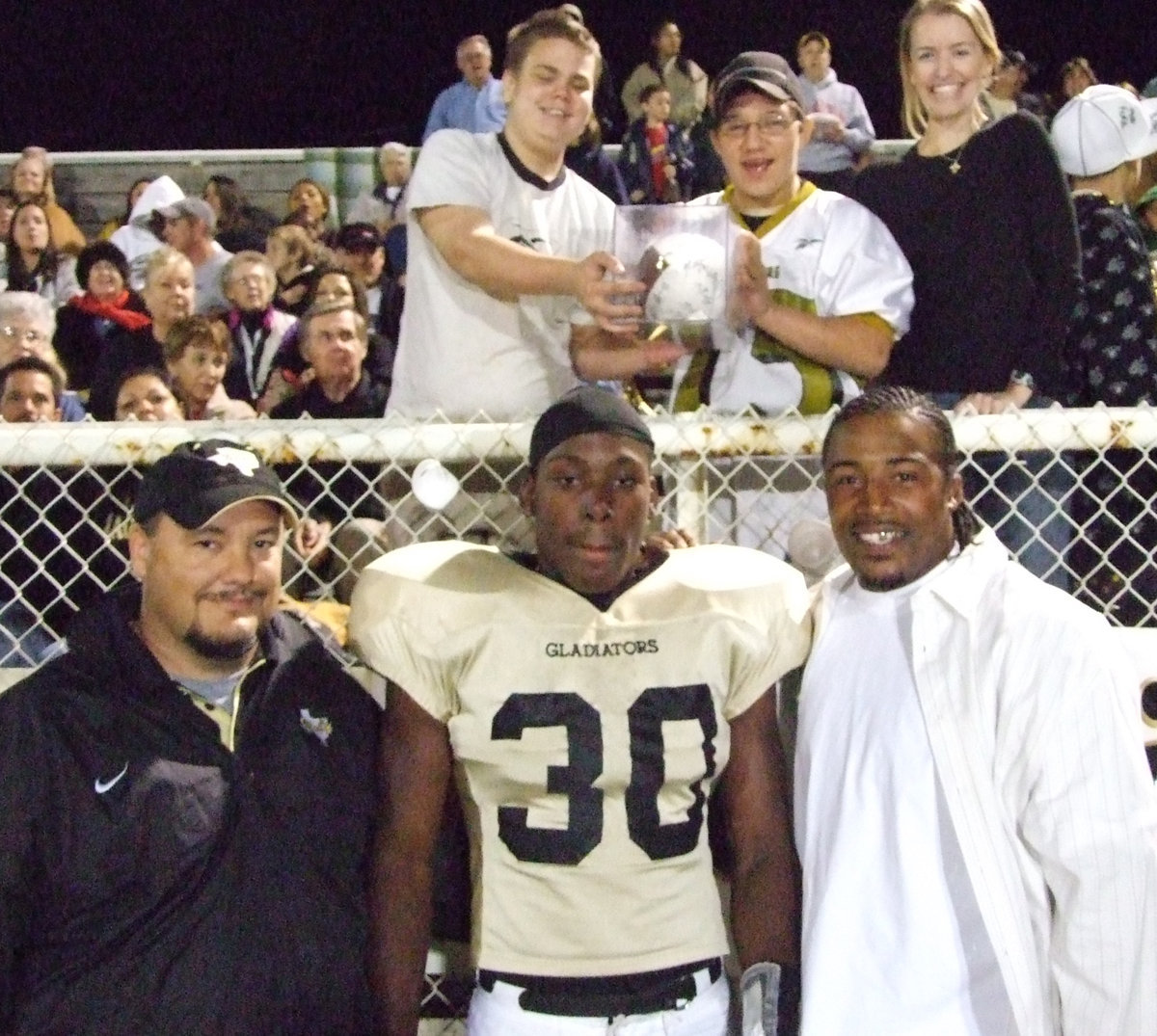 Image: CB&amp;I Class Wins — Coach Bales and Keith Davis give the football to Kelly Vernon’s CB&amp;I class.