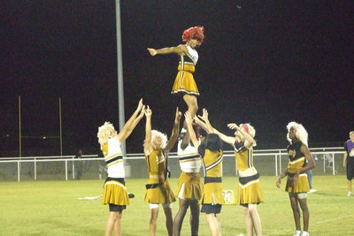 Image: La’Daishia stands tall — How many cheerleaders does it take to lift another?  (No answer).