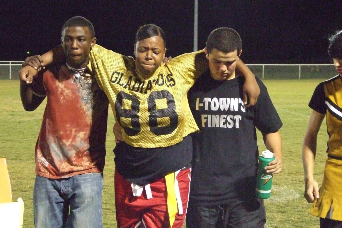 Image: Injuries occurred — Juniors and Seniors come together to help the injured off the field. Shay Shay Fleming is helped off the field by Diamond Rogers and Ross Enriquez.