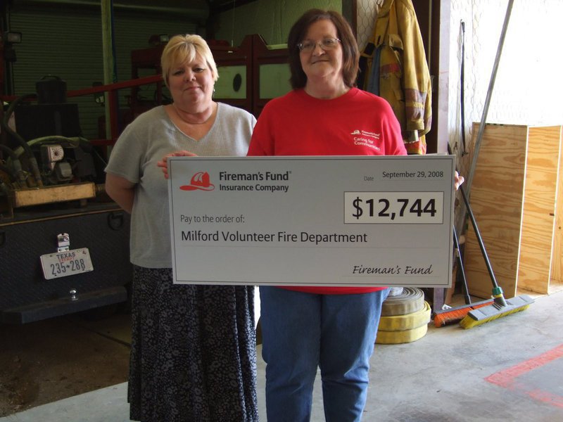 Image: Milford Fire Department grant. — Carolyn Parker and Peggy Duke of Fireman’s Fund Insurance presenting the bunker gear grant.