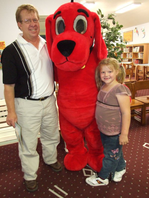 Image: Clifford gives hugs — Gary Clark, Sidney Lowenthal and Clifford the Big Red Dog all having a good time at the book fair.