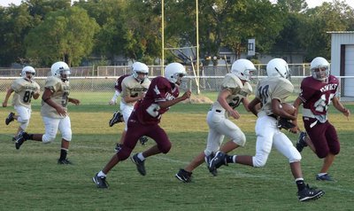Image: Running toward the goal — #20 Trevon Robertson carries the ball in 7th grade game.