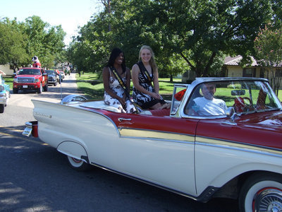 Image: Jameka and Shelby — Jameka Copeland and Shelby Gilley, freshman and junior princesses, ride in a beautiful convertible driven by Gary Wood.