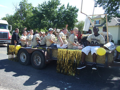 Image: Jr High Football — Coach Coker rides the float with the guys.