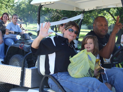 Image: Sunshine, Haley and Larry — Principal Parker, daughter Haley and Larry Mayberry throw candy at the crowd.