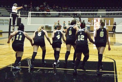 Image: Let the games begin — Lady Gladiator Varsity starters run to greet the Lady Cats.