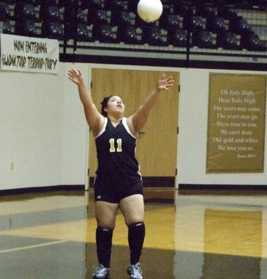 Image: Lady Gladiators serving — Senior Blanca Figueroa serves to the Lady Cats.