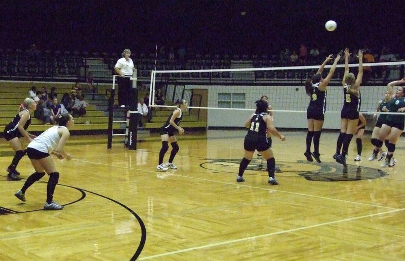 Image: Italy blockers get up — #9 Cori Jeffords and #5 Becca DeMoss try to block the ball.