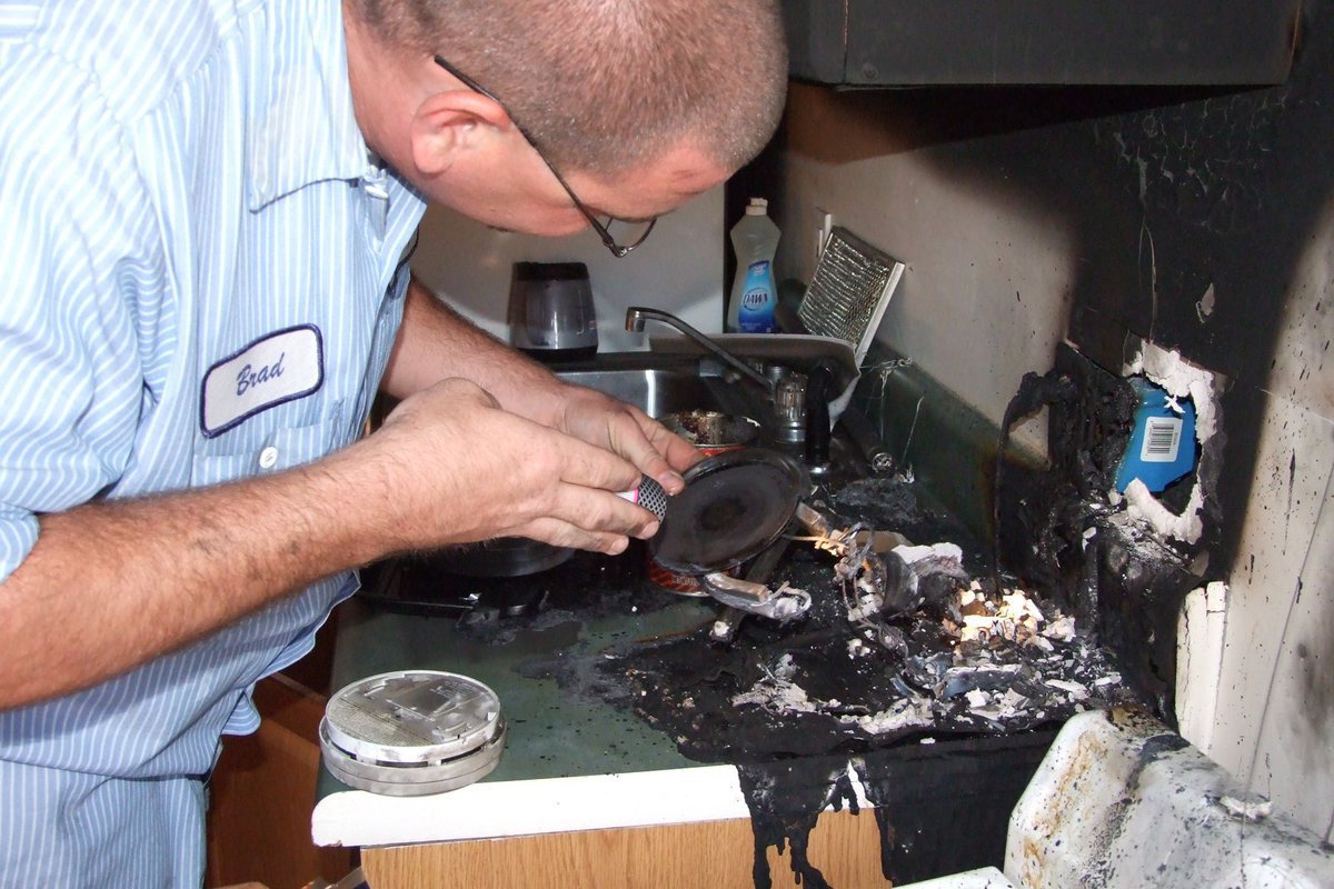 Image: Inspecting the damage — Fireman Brad Chambers inspects the coffee pot.