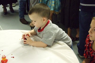 Image: Future firefighter — Austin Cate plays with one of the fire trucks at the luncheon.