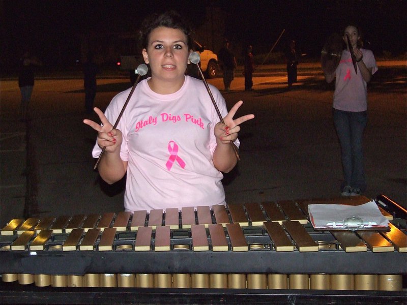 Image: Molly multitasks — Molly Haight can play notes, encourage world peace, promote breast cancer awareness and be a drum majorette.