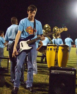 Image: Getting the bass ready — Ronald Helms plays the bass with the band.
