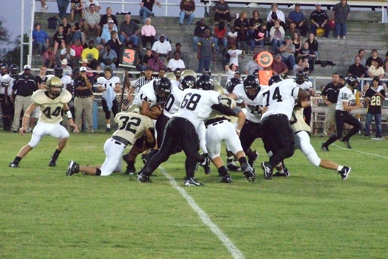 Image: Defense — Malakoff offense tries get through the Gladiators.