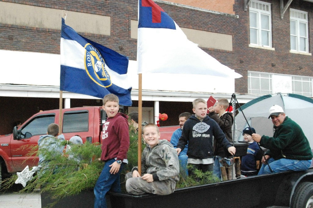 Image: Royal Holiday — Royal Ambassadors share a pot of food and a friendly smile with the Christmas parade watchers.