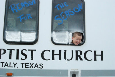 Image: Where’s Walton? — Italy’s First Baptist Church uses Bailey Walton’s head to decorate the side of their bus for the parade.