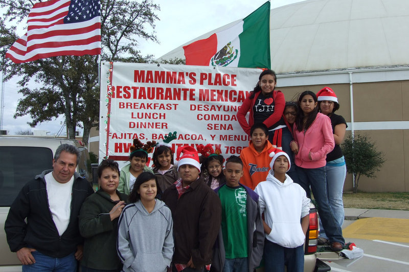 Image: Mamma’s Place Joins The Fun — Mamma’s family poses with their festive float before the big parade heads into downtown Italy.