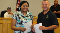 Image: Amber Mitchell receives $500 scholarship from DCI Sanitation representative, David Ingram.