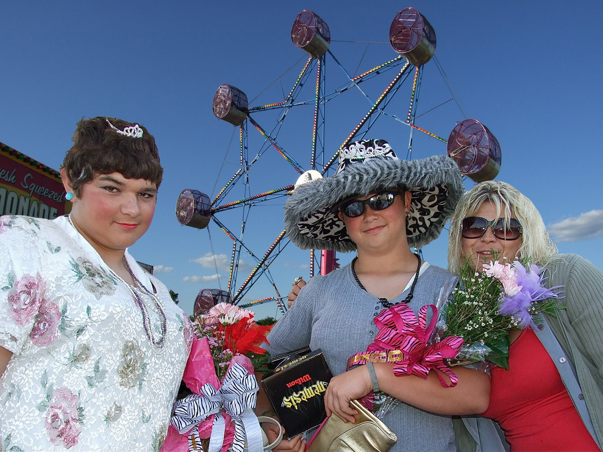 Image: The IYAA Sports Carnival Princess, Kevin Roldan, and the queen, Zain Byers, are ceremoniously crowned by event coordinator, Micki Bland. Both beauties received flowers and footballs as well.