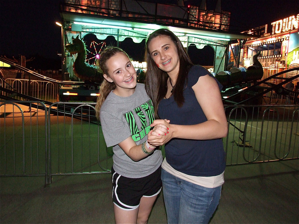 Image: Kelsey Nelson and, Brianna Burkhalter, enjoy some dance music performed by the Justin Guthrie Band.