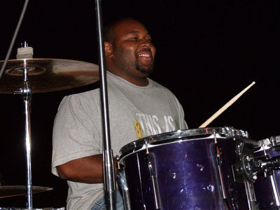 Image: Shedric Walker keeps up the beat while performing on the drums as a member of the “Justin Guthrie Band.”
