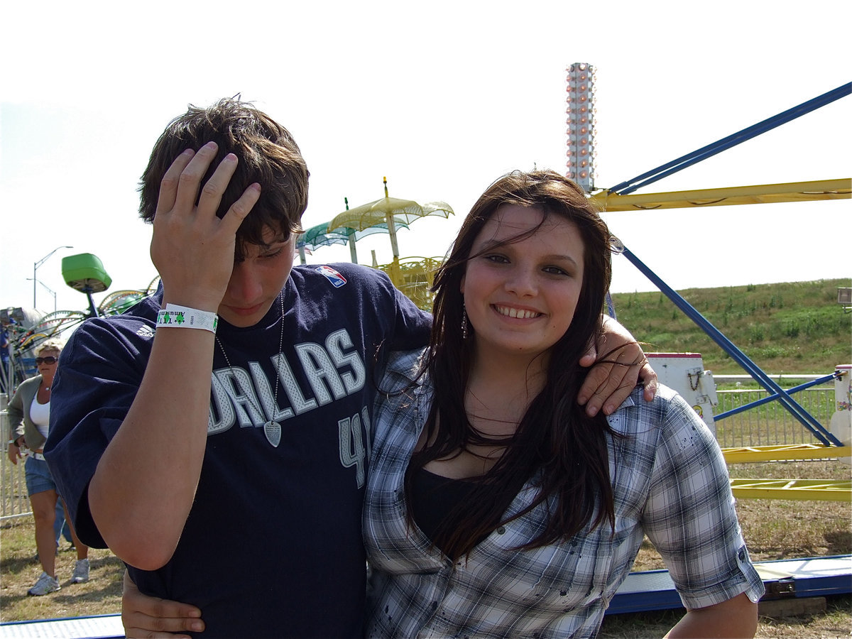 Image: Cori Jeffords helps her little brother, Coby Bland, while he gathers himself after riding the scrambler.