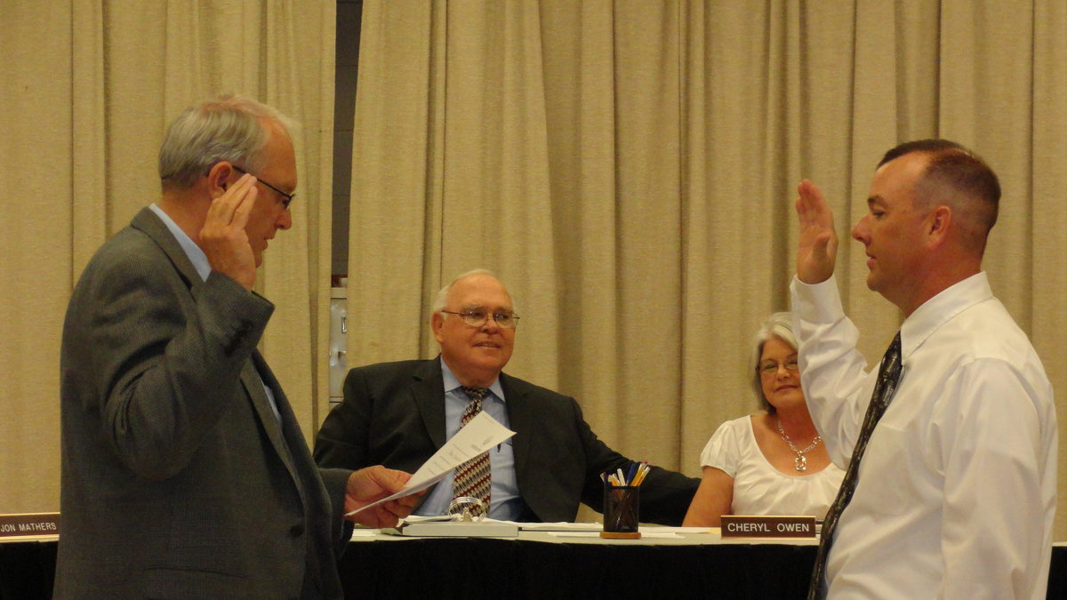 Image: Darrell Cockerham administers oath of office to his son Paul Cockerham.