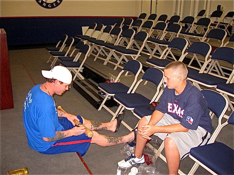 Image: Josh Hamilton, of the Texas Rangers baseball organization, signs a bat for Kolton Smith while the two were visiting during Kolton’s treatment for leukemia.