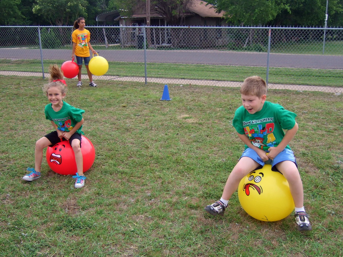 Image: Hippy-hoppy race is what this one is called. These first graders are ready to race. The have to bounce down to the end of the field without falling off.