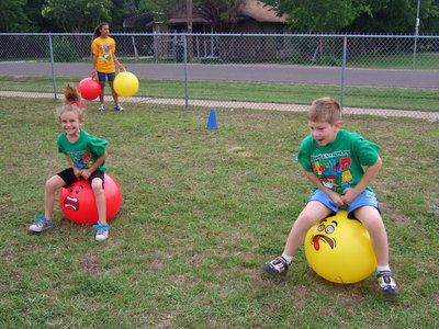 Image: Hippy-hoppy race is what this one is called. These first graders are ready to race. The have to bounce down to the end of the field without falling off.