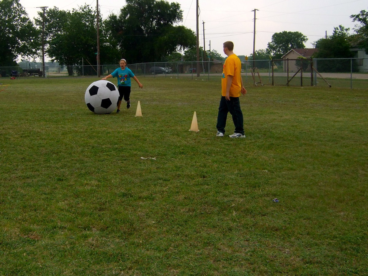 Image: Think she is going to get the ball around the cones?