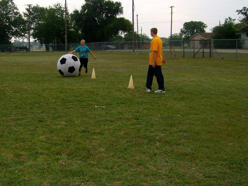 Image: Think she is going to get the ball around the cones?