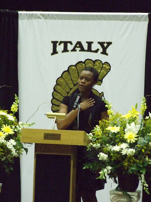 Image: Brianna Burkhalter beautifully sings our National Anthem for the crowd.